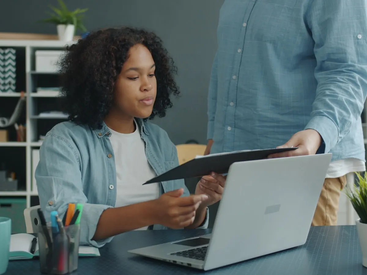 Two people reviewing documents and paperwork together